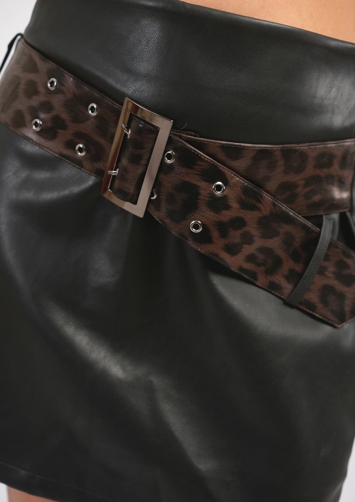 High-Fashion Leather Skirt with a Vibrant Leopard Belt